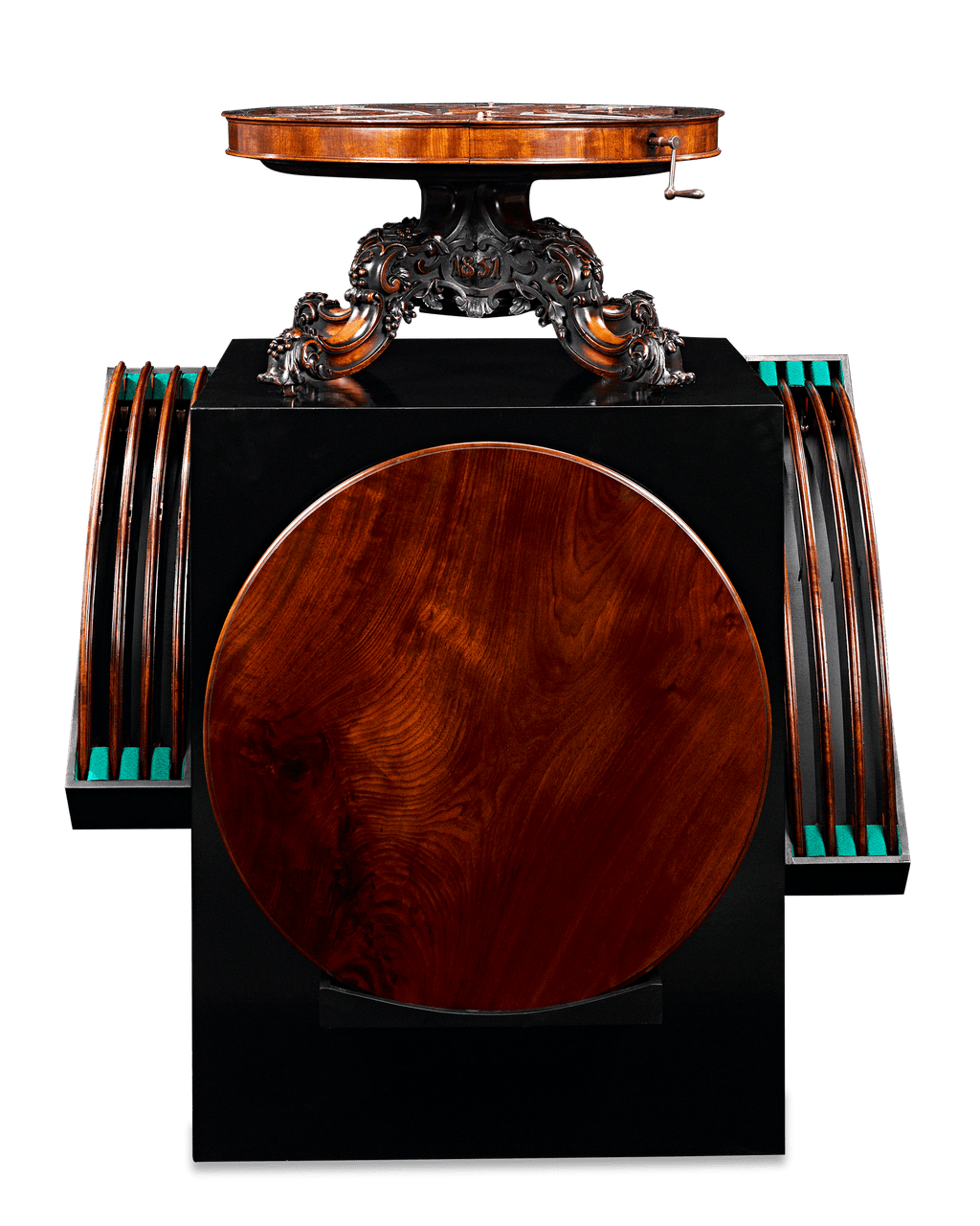 When the top is turned, its mechanism extends the table outward to accommodate additional leaves