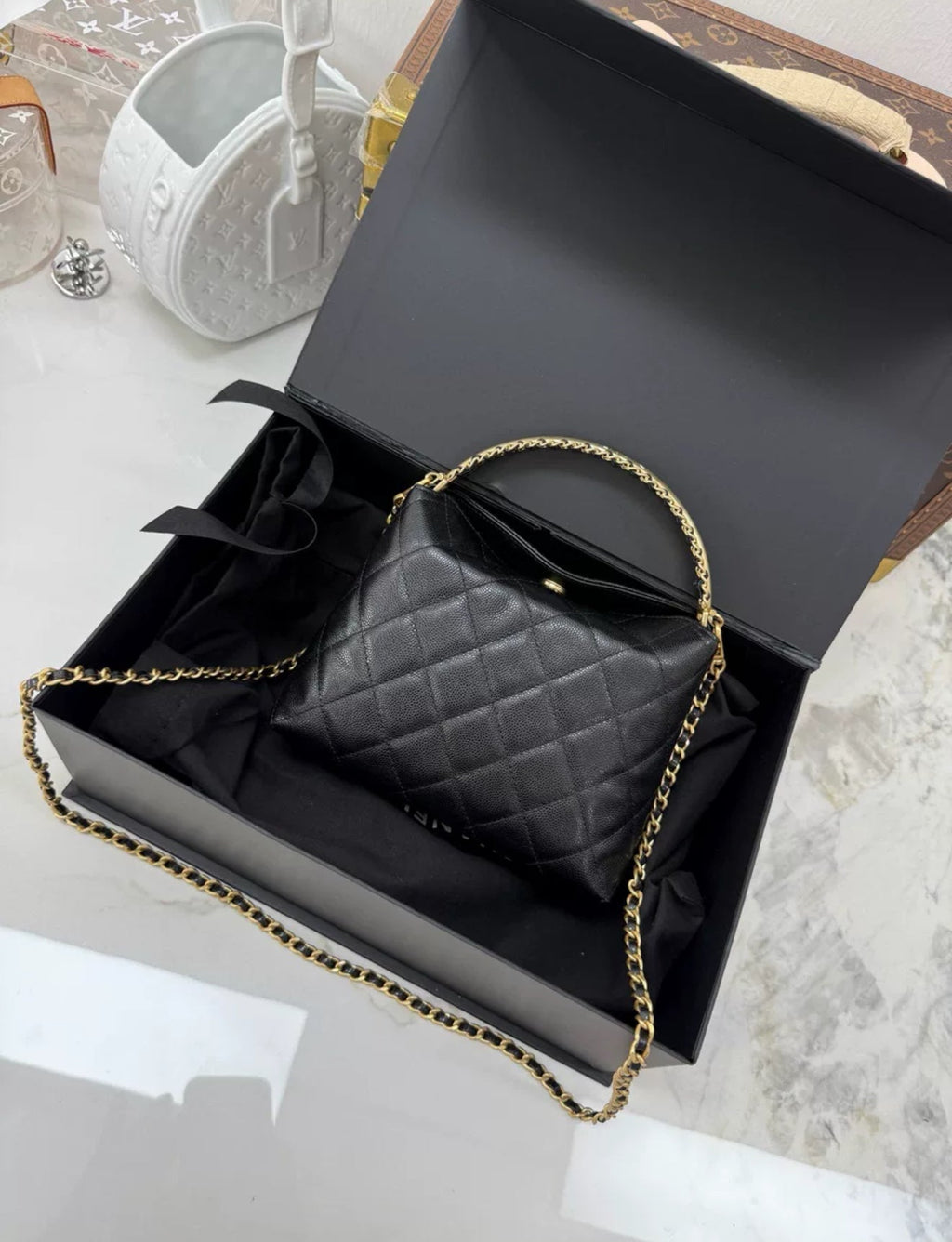 Chanel 24A black leather gold hardware top handle bag