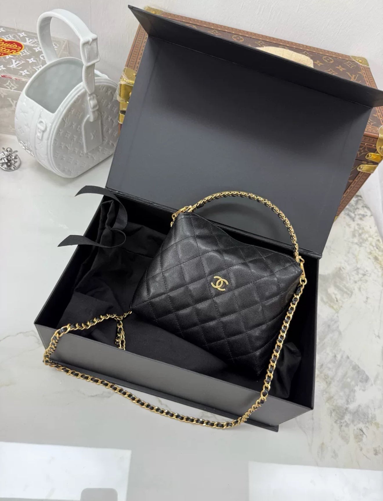 Chanel 24A black leather gold hardware top handle bag