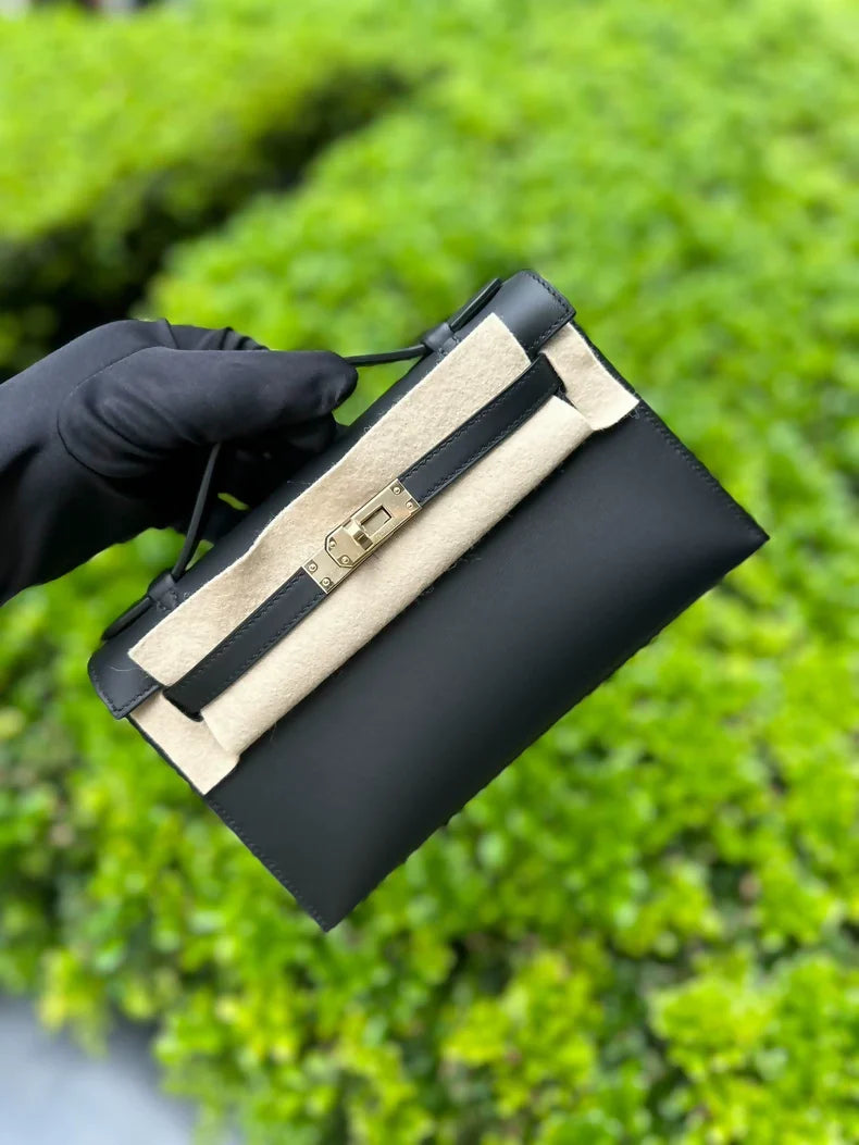 Hermès Kelly pochette black swift leather with light gold hardware