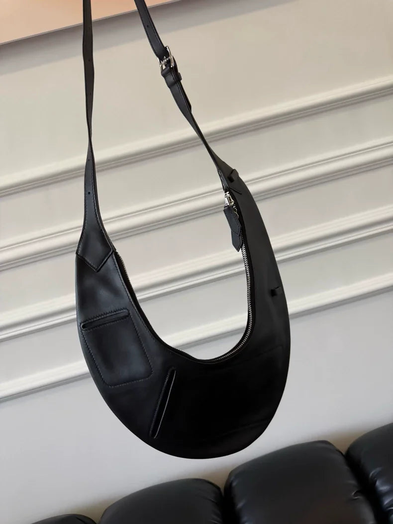 Hermès reversible black and silver clutch presented on the catwalk in 2023